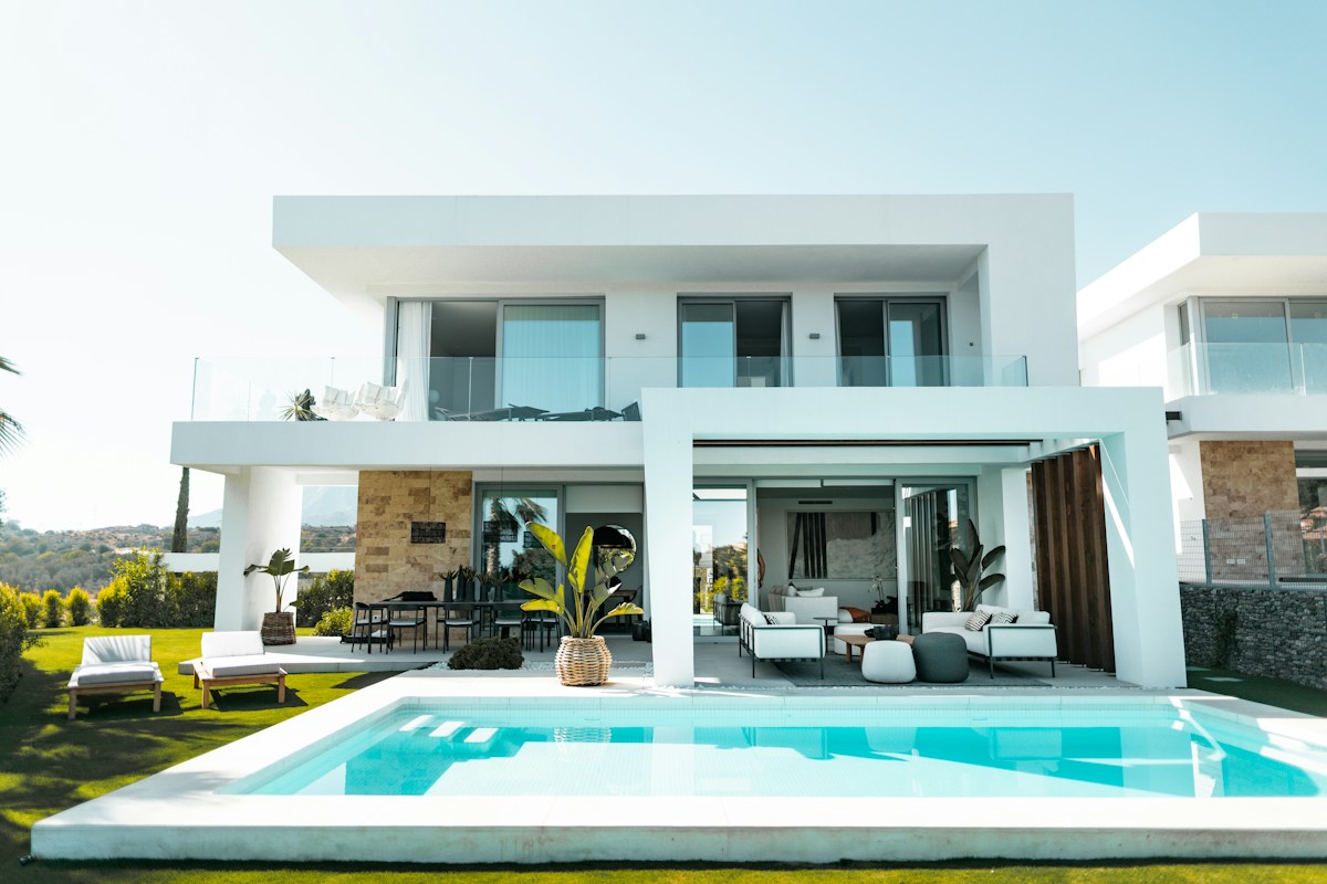 Outdoor living space and garden beside a pool